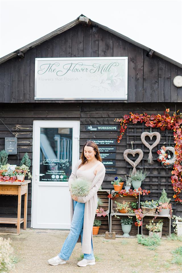 The Flower Mill Owner Kirsty standing outside the flower studio at Trumpetons Farm in Bedfordshire. What started out as a small florist shop has flourished into a thriving florist studio at Trumpetons Farm in Thorncote Green offering flower bouquets delivered locally, personal funeral flower arrangements, a whole range of floristry workshops through out sister company The Bedfordshire Flower School and timeless wedding flowers.